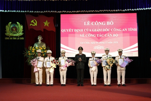 Đại tá Nguyễn Viết Giang - Giám đốc Công an tỉnh trao quyết định và tặng hoa chúc mừng các đồng chí được điều động, bổ nhiệm