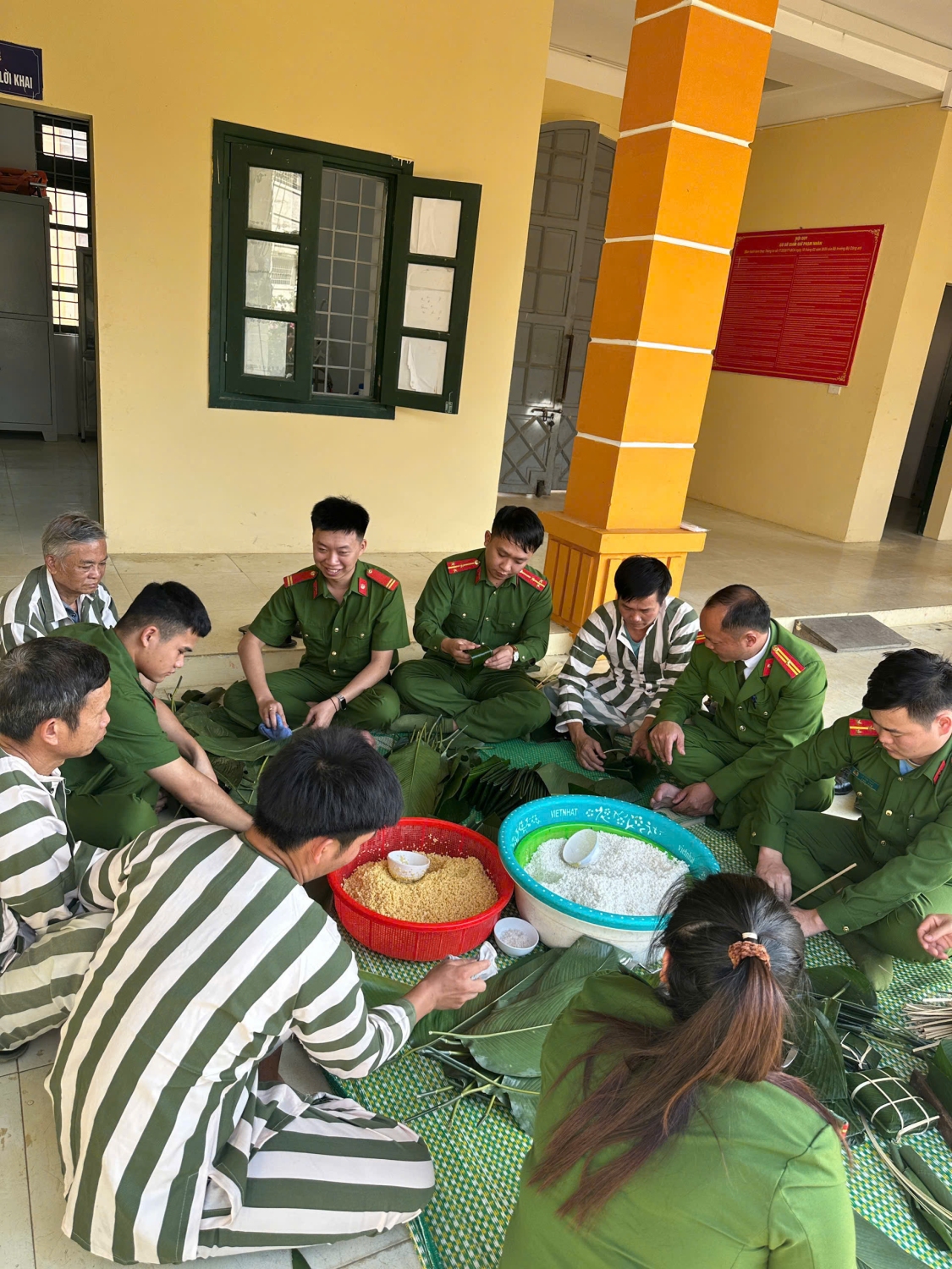 Đồng chí Sùng A Sài Trưởng phân trại tạm giam hướng dẫn cho can phạm nhân gói bánh chưng