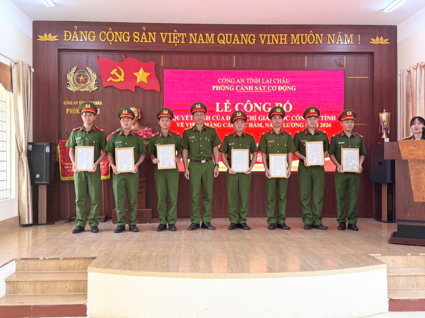 'A group of people in uniform holding certificates

Description automatically generated'